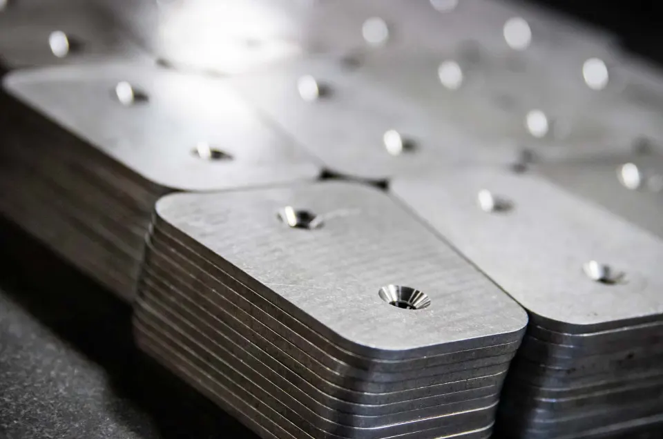 Stacked machined steel backing plates with countersunk bores
