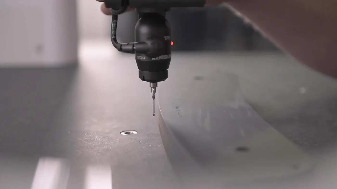 CMM probe measuring a friction plate on the inspection table